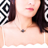 Antique style necklace with black enamel flower and brass leaves