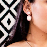 Opal earrings on ear