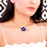 Royal blue enamel flower & antique brass leaves necklace