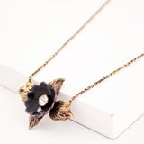 Antique style necklace with black enamel flower and brass leaves