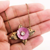 Antique style necklace with pink enamel flower and brass leaves
